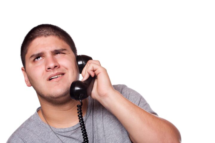 A man listening patiently to an annoying phone conversation